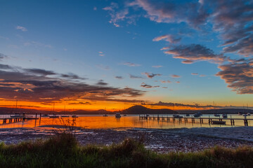 Sunrise waterscape with boats and clouds