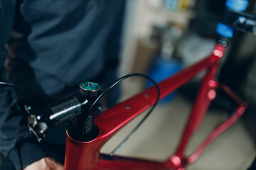 Mechanic repairman assembling carbon fork with wrench custom bicycle in workshop