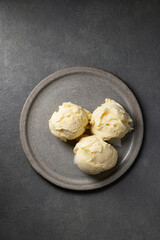 three ice cream balls on grey plate