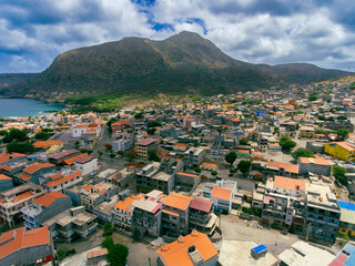 Naklejka na ściany i meble Aerial photos of Tarrafal in Santiago Island, Cabo Verde showcase the stunning beaches and clear waters of this idyllic coastal town, as well as its colorful buildings, charming streets