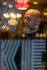 Portrait of a middle aged male with a bald head and a beard. Hipster. High quality photo