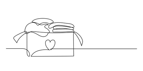 Clothes donation. Donation box with heart full of clothes. Continuous line drawing.