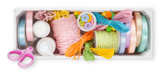 box with Rolls of satin bright ribbons and strings for decorations, tools for embellished and wrap package for festive, Easter, Christmas, wedding and birthday. Top view Isolated on white background