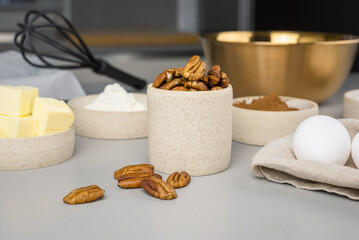 Close-up of the ingredients for brownie on a grey surface in the modern kitchen. Culinary blog.