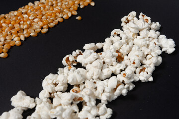 Corn and popcorn grains in two rows on a black background.