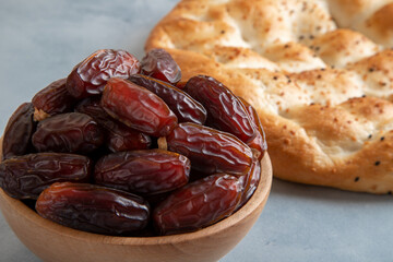 Date fruits,traditional ramadan pita on bright background,top view