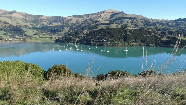 Boats at anchor in very calm water on a beautiful morning - French Farm Bay, Akaroa Harbor (New Zealand)