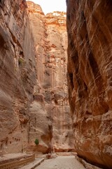 Jordan. Peter. Only road to rock city of Nabatean kingdom, to ancient city of Petra.Canyon Siq or El Siq. Sheer cliffs of a canyon or rocky cleft, 92 to 182 meters high, hang over narrow path.