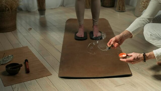 Palo Santo during standing on sadhu nails board in yoga studio. Incense used to treat pain and stress, clear negative energy. Ceremony