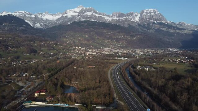 Aerial panning right revealing the Arve valley and the town of Sallanches. Haute Savoie, France. The A40 highway (called Autoroute Blanche) comes from Chamonix and Mont Blanc tunnel, Italy.