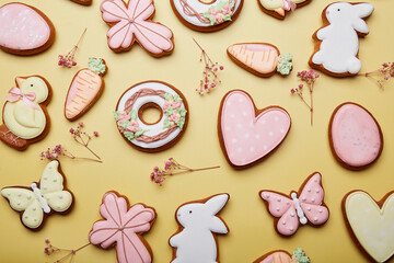 Easter cookies background among gypsophila. Baked glazed symbols of Easter. Spring easter card top...