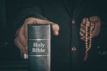 Holy Bible in men's hands. The concept of faith and religion. christian faith. priest is holding a book.