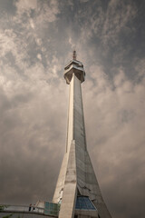 Obraz premium BELGRADE, SERBIA - JULY 24, 2022: Avala tower, or Avala toranj, seen from below. It is a TV tower and broadcasting antenna in the suburbs of Belgrade, Serbia.