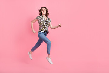 Full size profile photo of crazy satisfied girl jumping run empty space isolated on pink color background