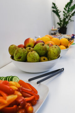 Plates of fresh fruit and vegetables for breakfast at the hotel. Vertical Image.