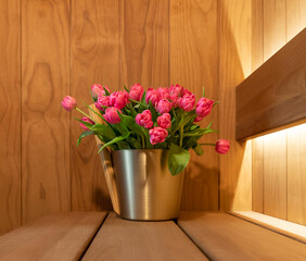 Sauna accessories and bouquet of spring tulips
