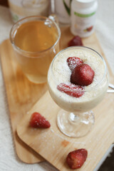 Fresh and delicious vanilla smoothie with strawberry garnish. Ideal healthy breakfast	