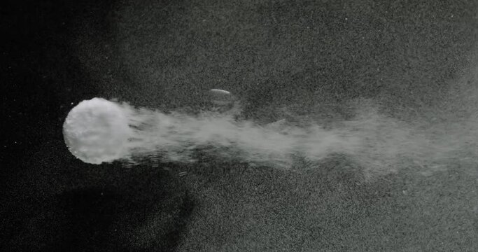 Effervescent antacid tablet in glass of water on black background
