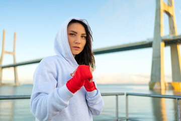 Woman boxer in fighting stance looking into the camera