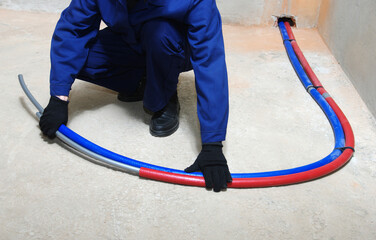 Plumber installing plastic pipes