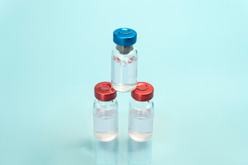 Medical Glass vials for liquid samples o n blue background. Medicine, Pharmacology, Laboratory, Production Macro