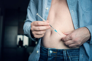 injecting insulin at home. young man hand using insulin syringe close up . self-medication