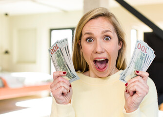 young adult pretty blonde woman with banknotes