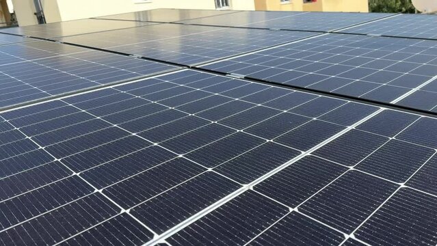 Closeup of surface of photovoltaic solar panels mounted on building roof for producing clean ecological electricity. Production of renewable energy concept.