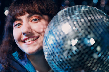 Young sporty woman 80 and 90's style. 90s fashion positive girl at night club disco party with disco ball