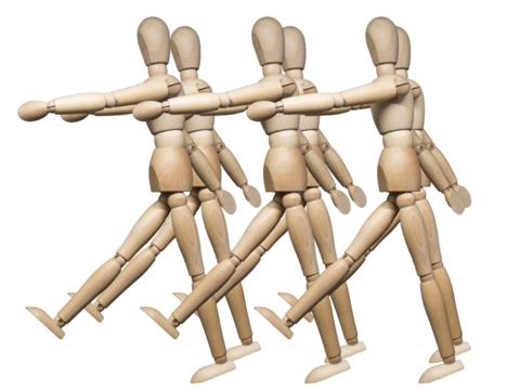 Wooden jointed figures posed as squad of marching soldiers