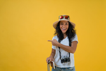 Happy Traveller curly latin woman wears white t-shirt with suitcase bag, passport and boarding...
