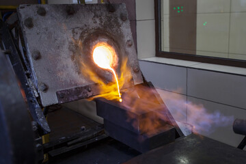 Pouring hot liquid gold into molds.