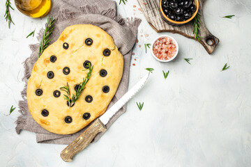 homemade focaccia bread baking with seasonings on a wooden board. banner, menu, recipe place for text, top view