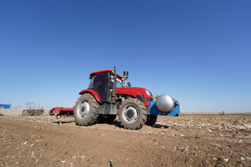 In spring, farmers use farm machinery to grow peanuts