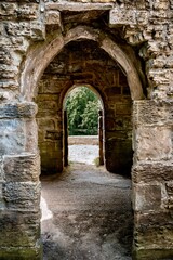 Fototapeta premium Stone archway in woodland at Hardwick Country Park, Sedgefield, England
