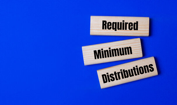 Three wooden blocks with the text RMD Required Minimum Distributions