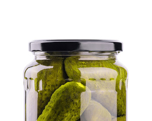 A glass jar of tasties canned cucumbers on white background