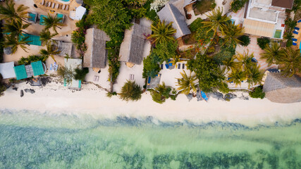 Fototapeta na wymiar The turquoise ocean water and the luxurious resort on Kiwengwa beach in Zanzibar, Tanzania, are captured in this gorgeous toned aerial view. The scenery is simply stunning, and it's a perfect destinat