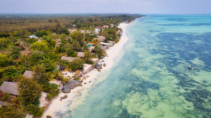 The turquoise ocean water and the luxurious resort on Kiwengwa beach in Zanzibar, Tanzania, are captured in this gorgeous toned aerial view. The scenery is simply stunning, and it's a perfect destinat