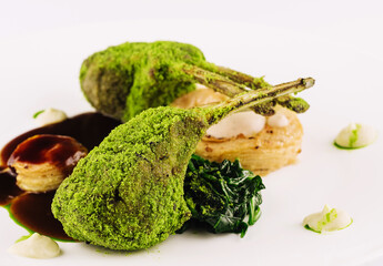 Grilled rack of lamb with mint and pistachio on plate