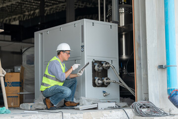 Industry engineer under checking the industry cooling tower air conditioner is water cooling tower...
