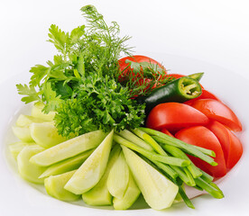 Vegan plate of fresh sliced cucumbers, green onions and cherry tomatoes