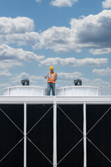 Industry engineer under checking the industry cooling tower air conditioner is water cooling tower...