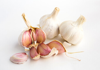 garlic heads and cloves on white background