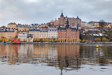 Fototapeta na wymiar Stockholm Gamla Stan buildings at waterfront with reflections, Sweden