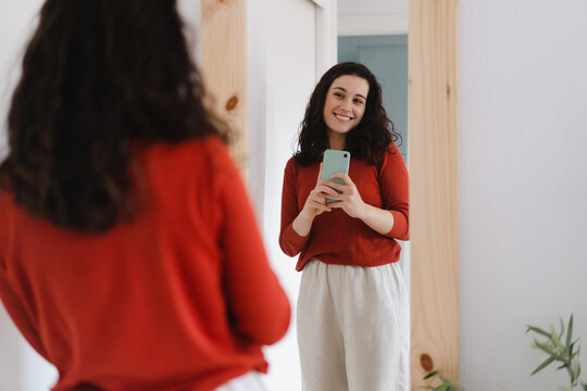 Young Happy Woman Taking A Selfie In Front Of The Mirror