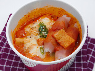 Delicious Korean spicy tteokbokki or ttopoki. The image of spicy tteokbokki on a luxurious  white background. Available negative space for writing text. Isolated and copy space