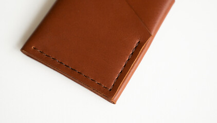 Empty men's business handmade leather card holder with isolated on white background. Selective focus, copy space, close up.