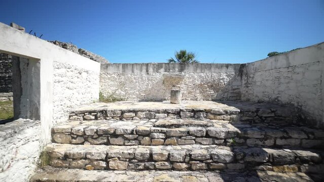 Camera pushing in through the catholic church area where sacrifices were done to show the original mayan ruins pyramid.