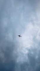 The plane is flying over a cloudy sky.